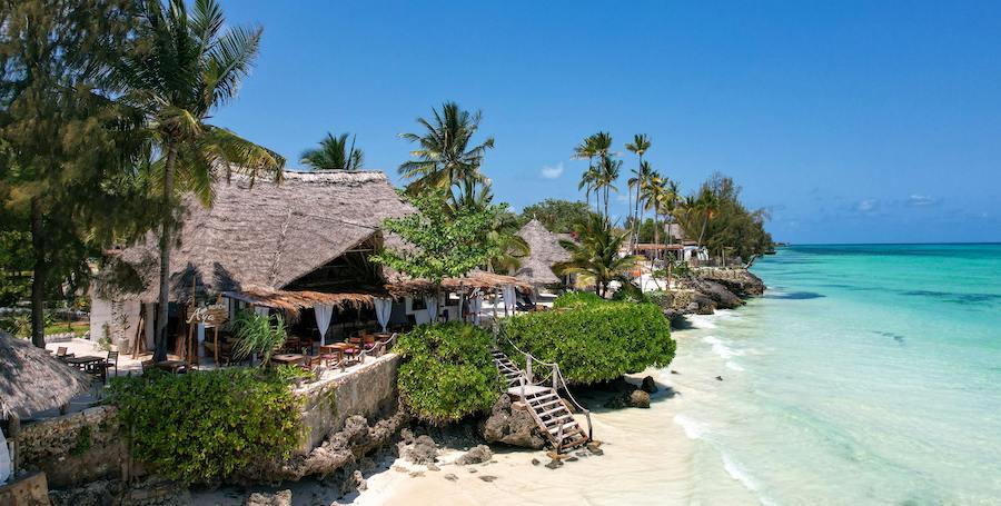 Beach view with thatched buildings Beach view with thatched buildings